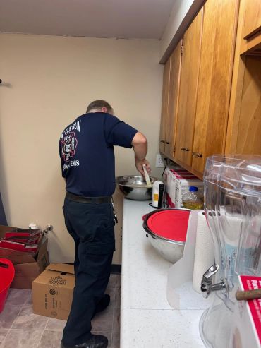 Man mixing ingredients in a kitchen.