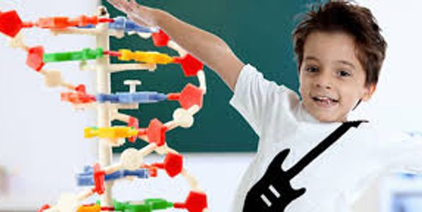Young boy excited about DNA model in science class.