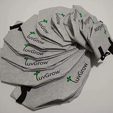 Stack of gray grow bags labeled 'luvGrow' with green plant logo.