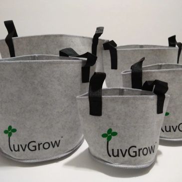 Set of gray fabric grow bags with black handles.