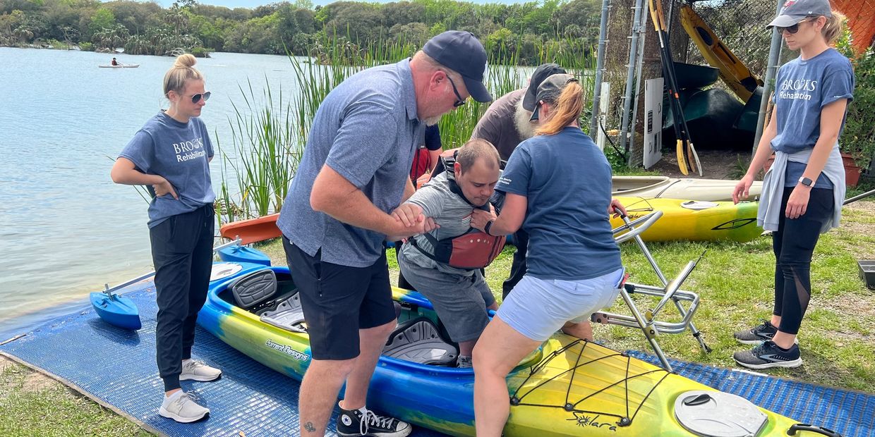 Volunteers and staff of Brooks Rehabilitation Adaptive Sports and Recreation kayaking at Hanna Park