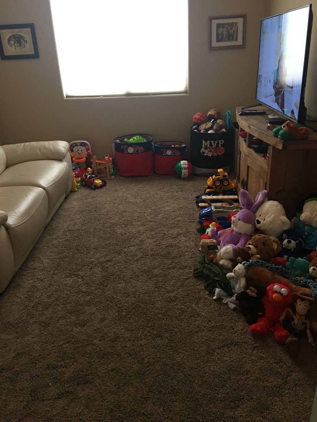 The after of the playroom with toys separated by age range and contained within baskets.