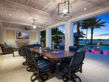 Luxurious outdoor dining area by the pool at sunset.