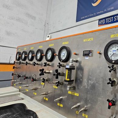 Close-up of a hydraulic test stand with multiple pressure gauges and controls.