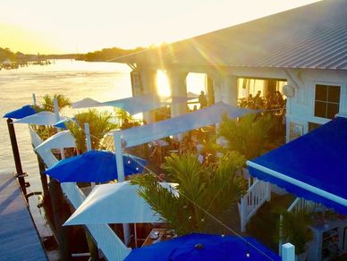 the porch on long creek in virginia beach virginia blue umbrella with sunset