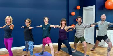 Group practicing yoga in a studio.