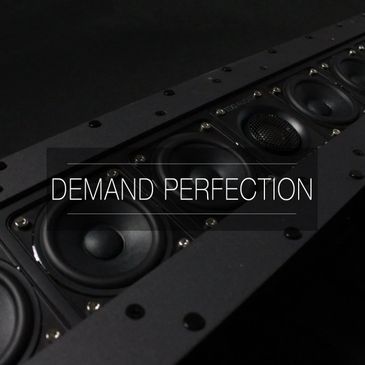 Close-up of a high-quality speaker with the text 'DEMAND PERFECTION'.