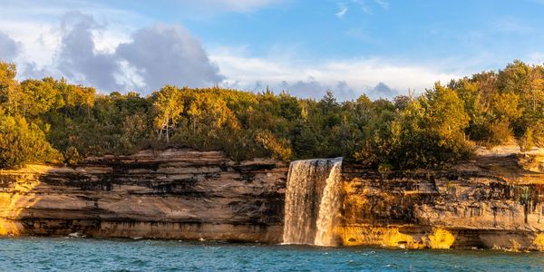 The waterfall Spray Falls goes over Pictured Rocks' edge into Lake Superior