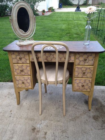 Stained top with paint/glaze finish and decoupaged drawer fronts.
