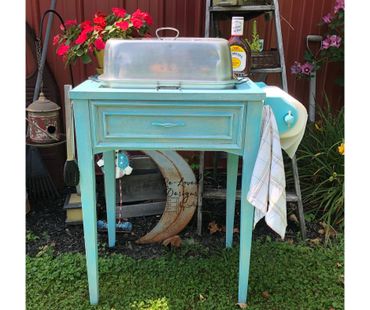 Upcycled vintage sewing machine cabinet into drink station. Multiple layers/colors of dry brushing.