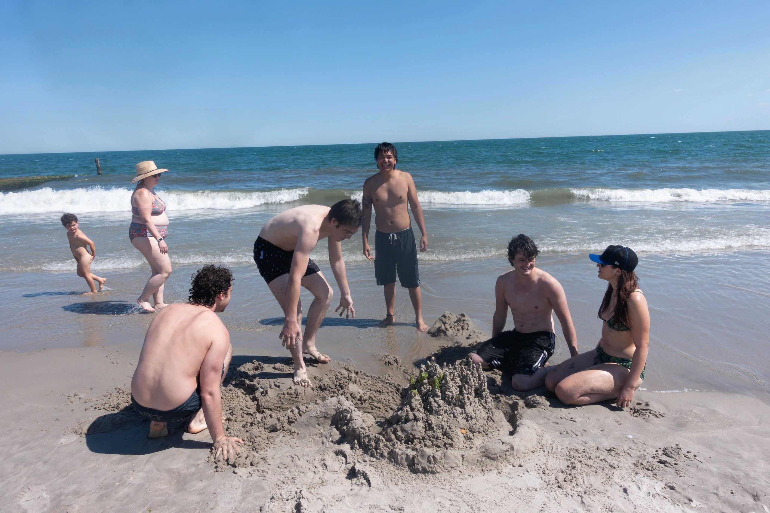 Group of people enjoying a sunny day at the beach.