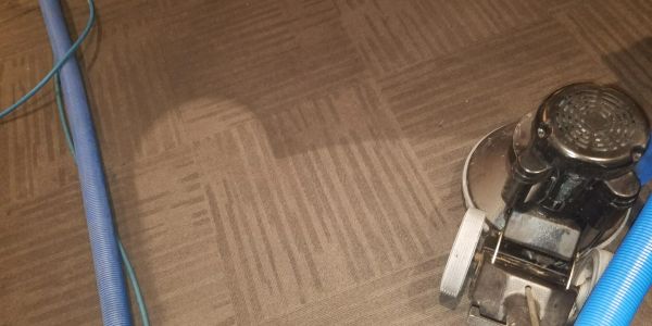Cleaning machine on carpet with a wet spot.