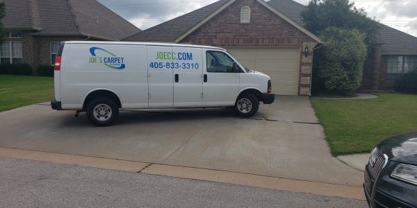 White van for Joe's Carpet parked in a driveway.