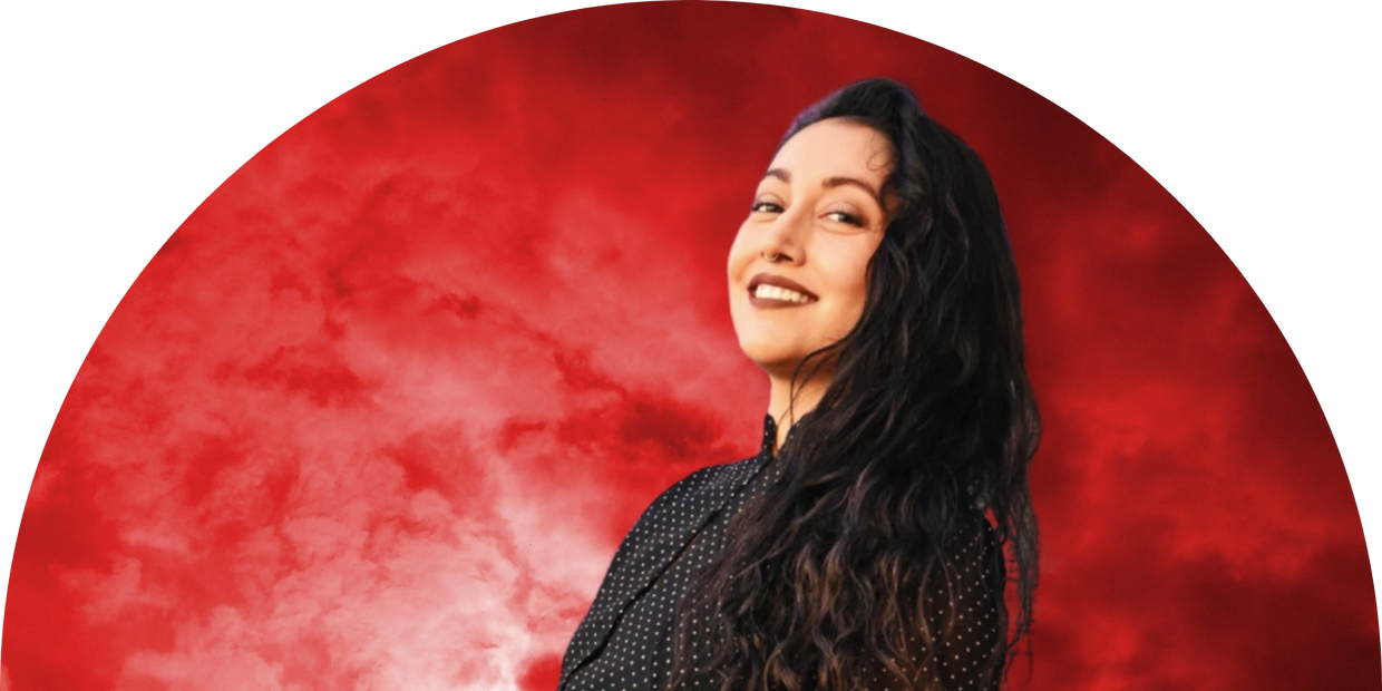 Half-circle image of smiling, dark haired, Latina in front of a red cloud background.