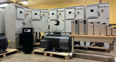 Industrial control panels and motor equipment in a workshop setting.