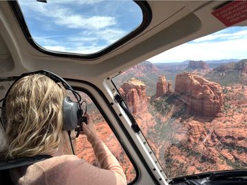 Woman taking photos from helicopter