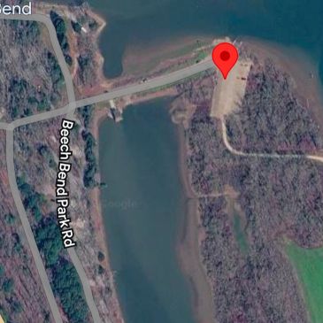 Aerial view of Beech Bend Park Road crossing a water body.