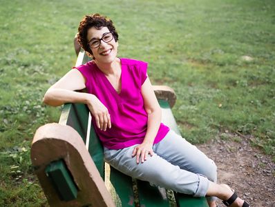 Laurie Santiago-Hooper of Holistic Recovery Coaching sitting outside