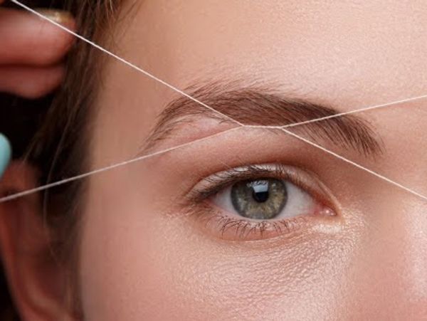 Woman getting eyebrow threading