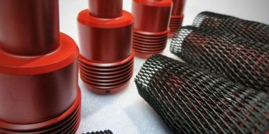 Red metal cylindrical objects and black mesh tubes.