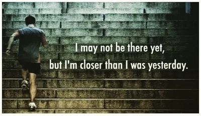 A man running up stairs with the phrase I may not be there yet, but I'm closer than I was yesterday