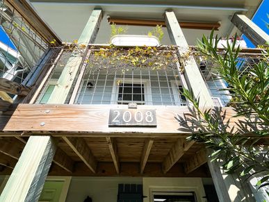 View looking up at a balcony with the number 2008 displayed.