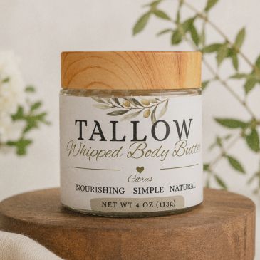 Jar of tallow whipped body butter with wooden lid.