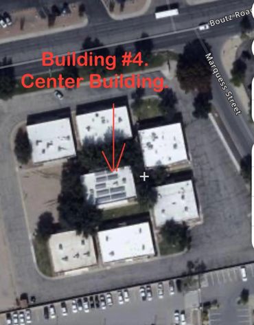 Aerial view of a building complex with a labeled center building.