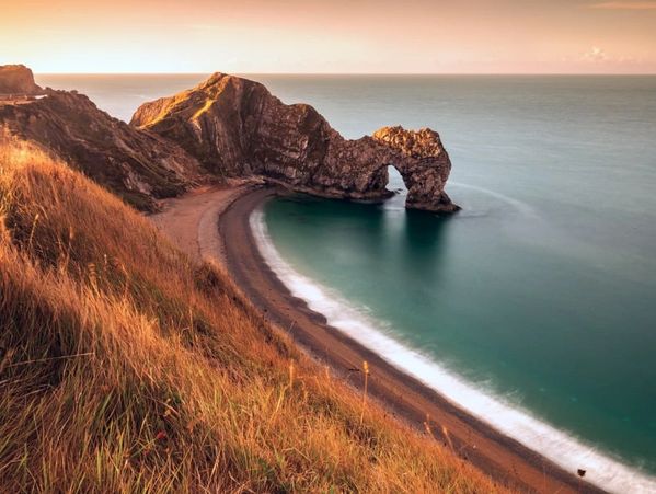 Coastal rock arch at sunset