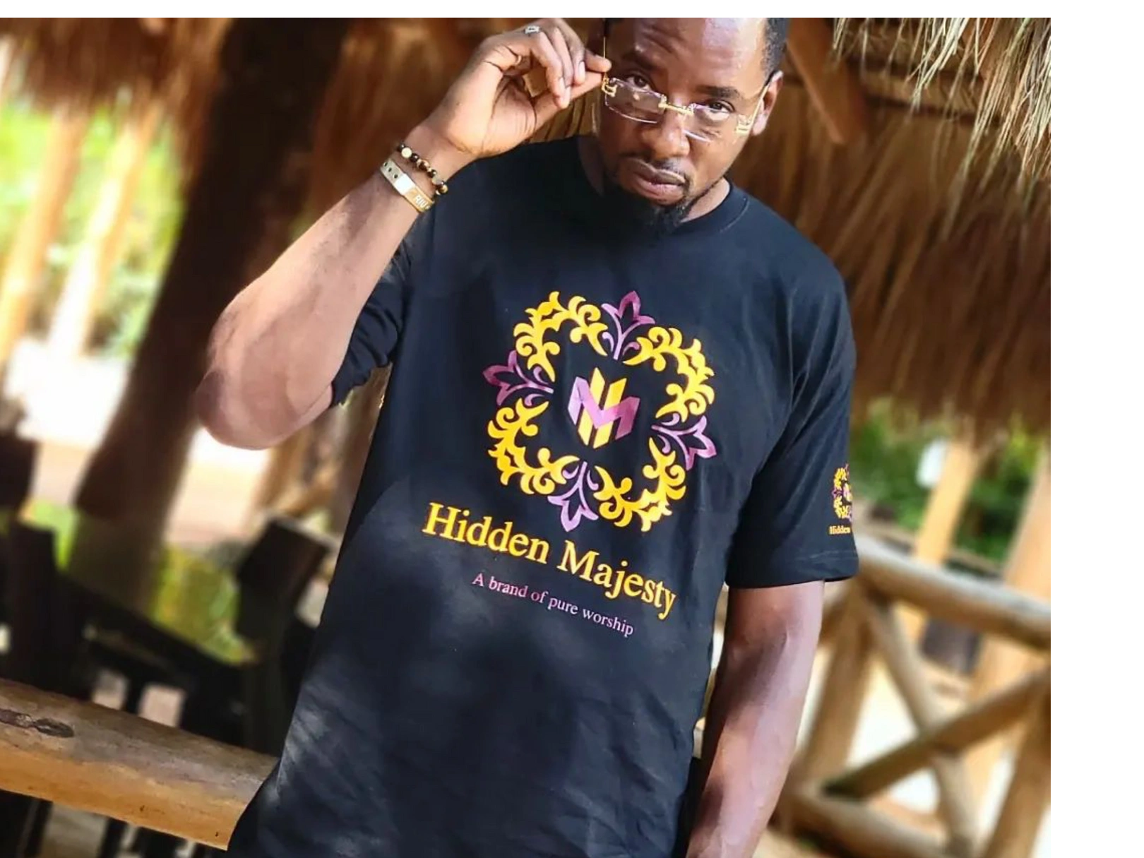 a man wearing a black Hidden majesty t shirt 
