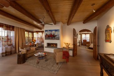 Cozy living room with wooden ceiling and fireplace.