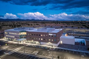 A modern medical building with "Nexens Health" signage at dusk.