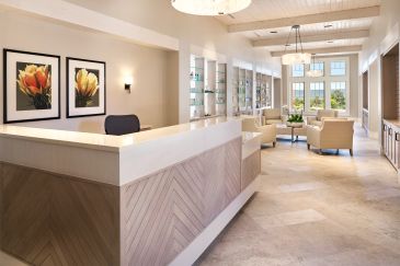 Modern reception area with beige tones and natural light.