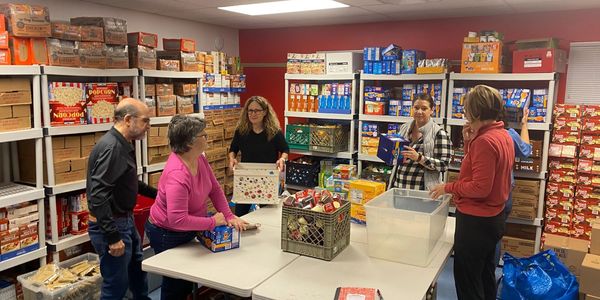 Helping Hungry Kids volunteers packing weekend food bags