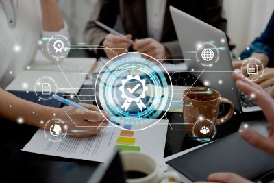 Business team collaborating with digital quality assurance icons overlay.
