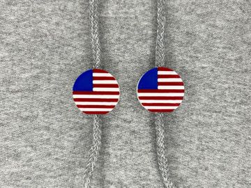 Red, white, and blue American flag charms on sweatshirt drawstring