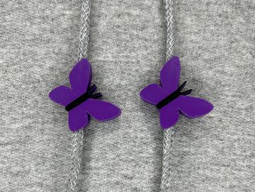 Purple butterfly sweatshirt charms on a grey sweatshirt