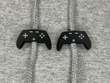 Black and grey game controller sweatshirt charms on a grey sweatshirt