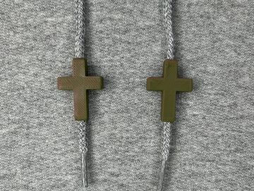 Green and brown crosses on a grey sweatshirt