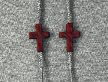 Red and blue crosses on a grey sweatshirt