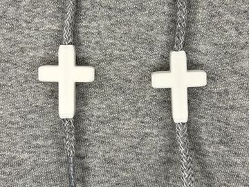 White cross charms on sweatshirt drawstrings