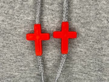 Red cross charms on sweatshirt drawstrings