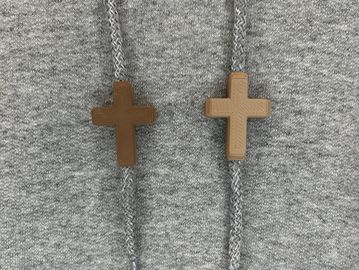 Brown crosses on a grey sweatshirt