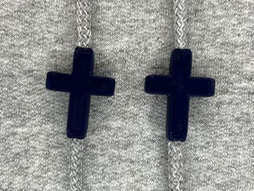 Navy blue crosses on a grey sweatshirt
