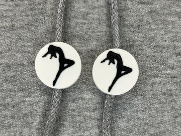 Silhouetted dance charm in white and black on sweatshirt drawstring.
