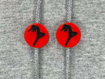 Silhouetted dance charm in red and black on sweatshirt drawstring.