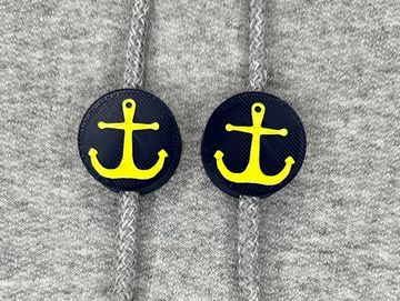 Navy blue and gold anchor charms on sweatshirt drawstring.