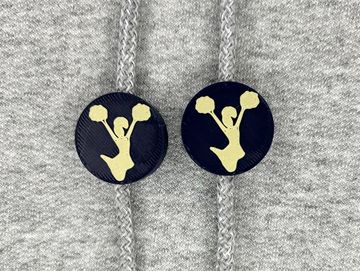 Silhouetted cheerleader charm in navy blue and vegas gold on sweatshirt drawstring.