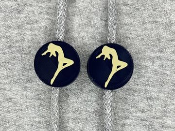 Silhouetted dance charm in navy blue and vegas gold on sweatshirt drawstring.