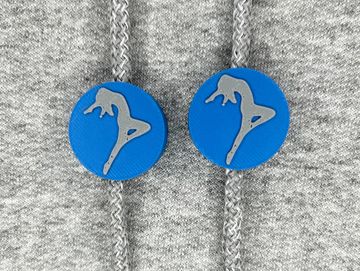 Silhouetted dance charm in royal blue and gray on sweatshirt drawstring.